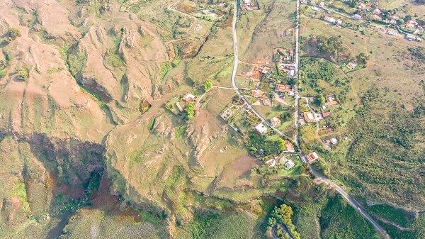 Aerial view of a rocky area with a village below.